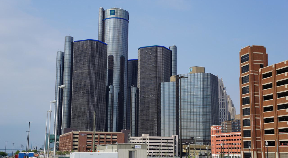 Downtown Detroit, Michigan. Tall and shiny office buildings, set against a blue sky. The MGCB has requested that operators be required to meet a new set of responsible gaming standards before they can participate in interstate online poker.